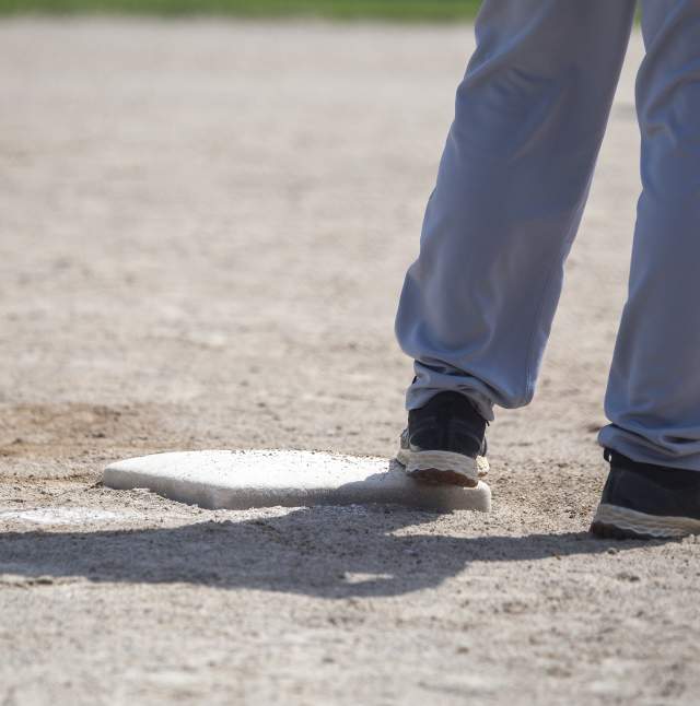 Softball player standing on a base