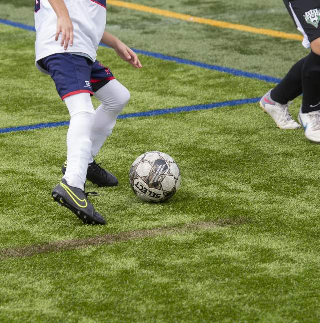 Players kicking a soccer ball