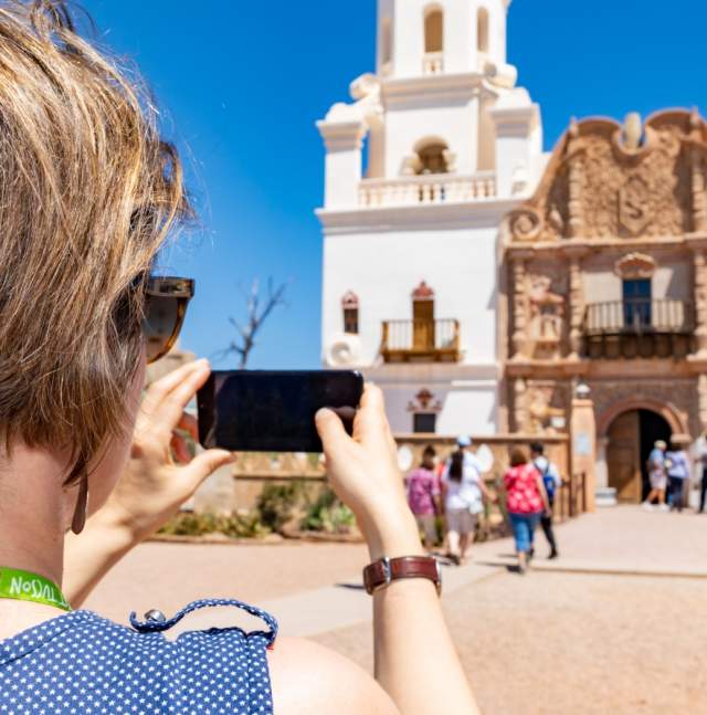 Woman Taking Photo at San Xavier Mission Exterior