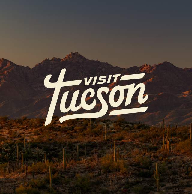 Visit Tucson logo on a mountain image background