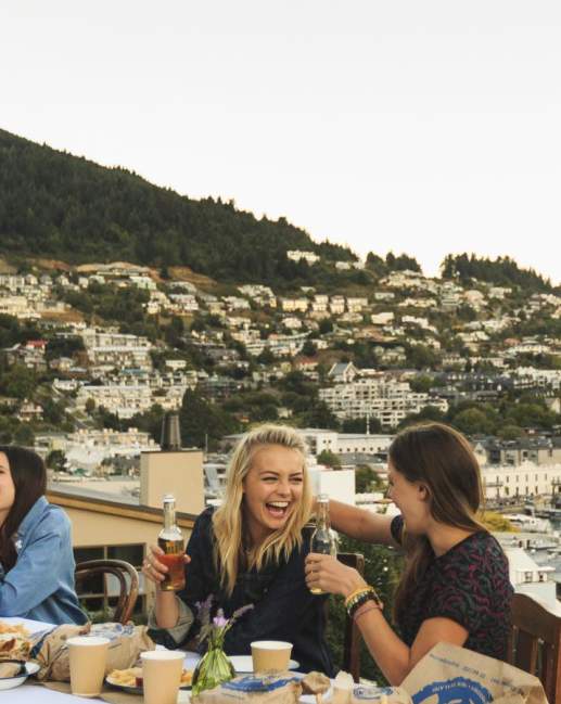 Backpackers dining on Queenstown Lakefront