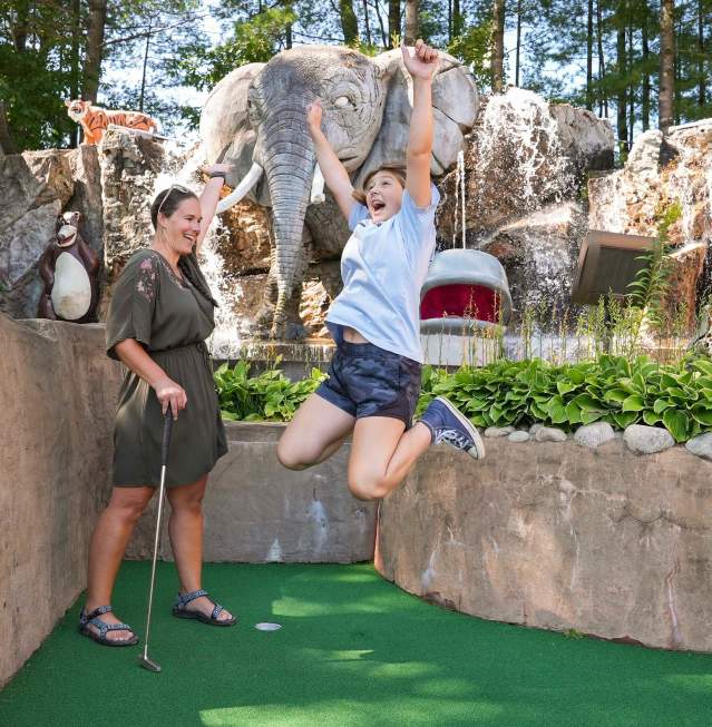 Mom and Daughter Playing Mini Golf