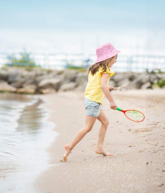 Girl Playing at Lighthouse Park Beach in Manitowoc