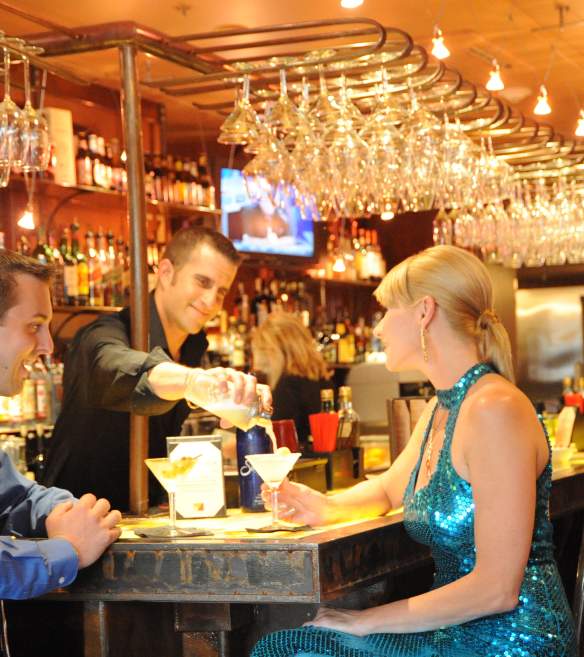 bartender seving drinks to a couple