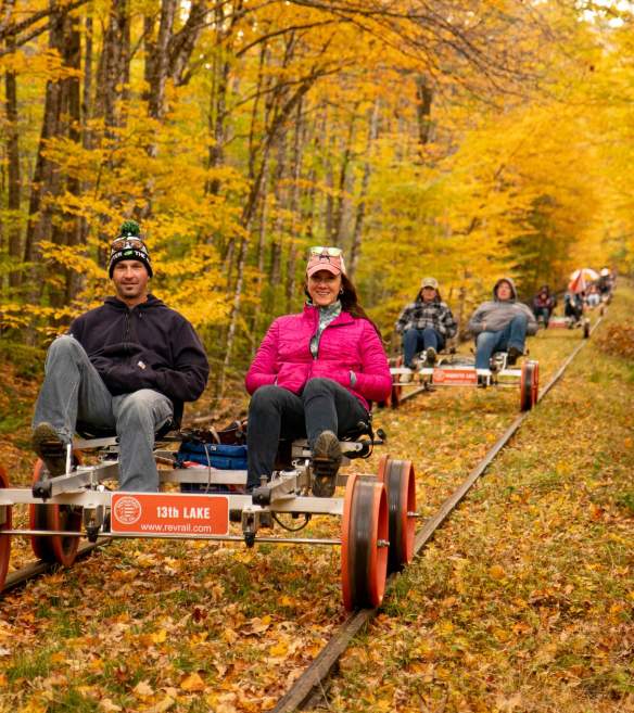 people trail biking in autumn foliage