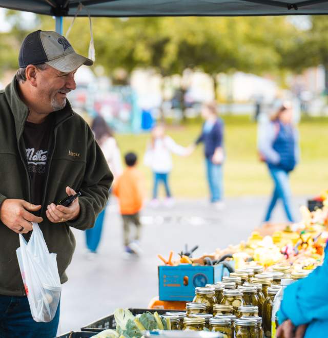 man shopping at farmers market