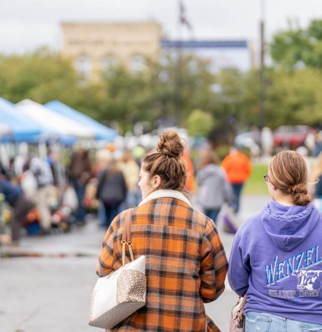 two girls walking at farmers market