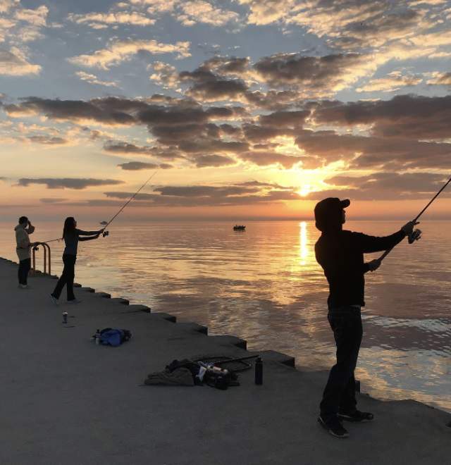 people fishing on the south pier in Manitowoc