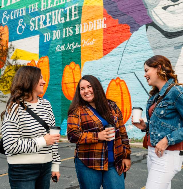 women in front of Ruth West mural in downtown Manitowoc Wisconsin