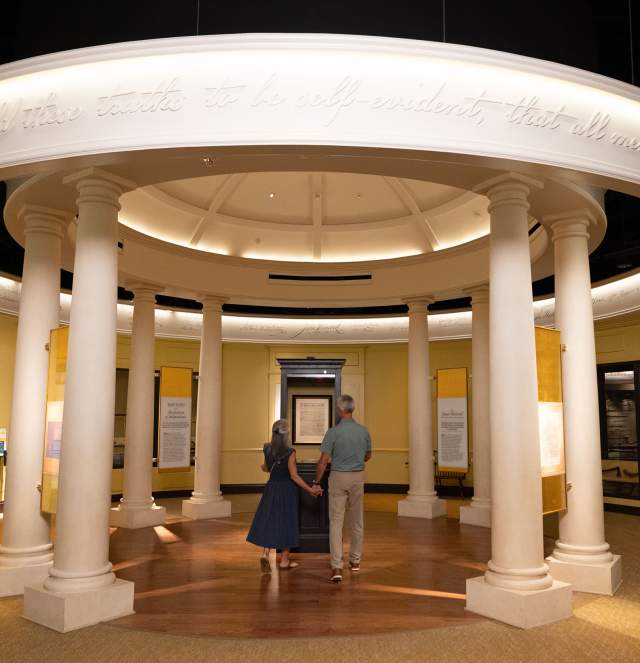An immersive gallery exhibit at the American Revolution Museum at Yorktown allows visitors to discover the powerful stories behind the Declaration of Independence, shown surrounded by signatures of this historic document’s signers.