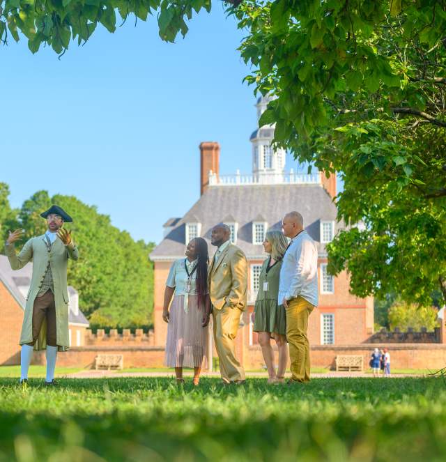 Group at Colonial Williamsburg listening to an interpreter dressed in a colonial outfit
