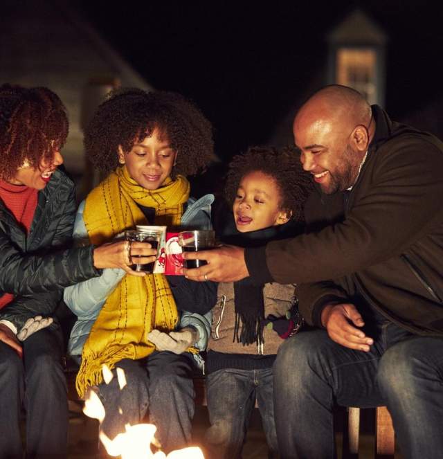 Family outside around the fire in Winter