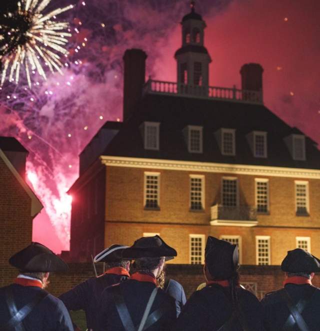 Colonial soldiers watching fireworks go off on the 4th of July