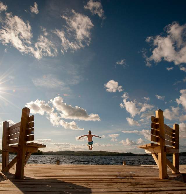 boy jumping off the dock