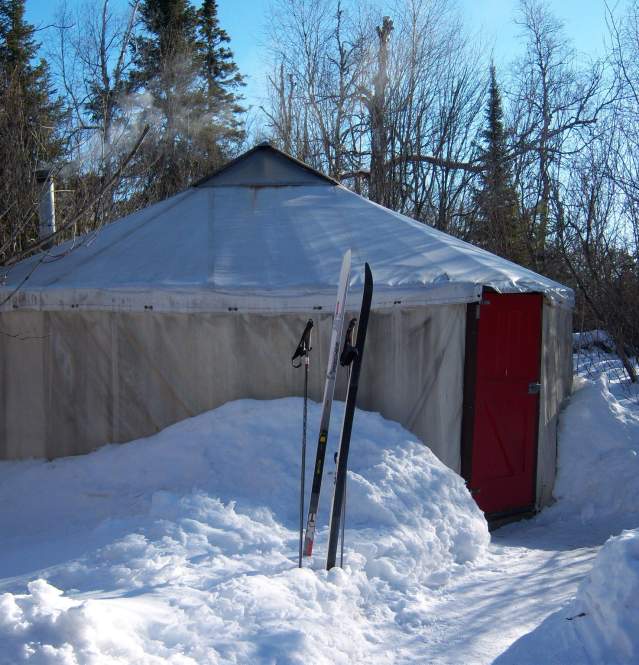 Skis outside of yurt in winter on the banadad ski trail