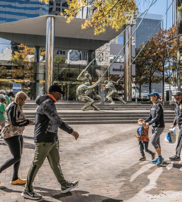 People walking by the Bank Of America Financial Center