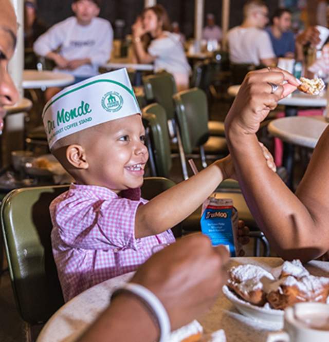 Family enjoying beignets at Cafe du Monde
