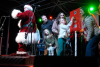 Santa and a local family stand on stage the child winner of the contest flips the switch to illuminate holiday lights in downtown Golden, CO.