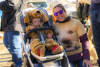 A baby dressed in a Golden retriever costume and parent with a golden retriever shirt at the 2022 Goldens in Golden event