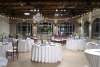 Room with tables decorated for a wedding reception