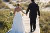 married couple walking on board walk