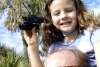 Little girl on dad's shoulders with binoculars