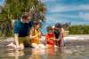 Family finding treasures in the water at at Stump Pass Beach State Park on a warm and sunny August day.
