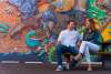 Airbnb Cheyenne WY-A couple sits on a bench talking with a giant mural behind them