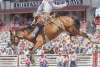 A cowboy competes on a bucking bronco at Cheyenne Frontier Days