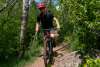 a man riding a mountain bike on a trail of aspens