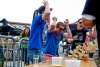 Men react as their jenga tower falls at the Wyoming Brewers Festival