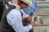a cowboy tapes his hands to participate in a rough stock event