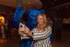 Attendee taking photo with a Blue Bear mascot
