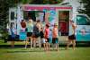 Locals getting ice cream from an ice cream truck.