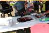 A man cutting a smoked rack of ribs into individual ribs.