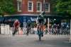 A professional cyclist rides in Centre Square past The Bayou restaurant during the 2022 Easton Twilight Criterium in Easton, Pa.