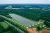 Lake surrounded by greenery and wooded areas, with paved hiking trails at Buffalo Lake in Elizabethtown, Kentucky