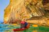 Image of a person paddling a kayak at Pictured Rocks National Lakeshore, located in Michigan's Upper Peninsula, USA