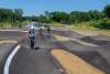 2 riders on bikes using the pump track