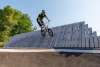 Rider up on curved wall at pump track