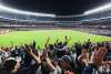 Nighttime game at Yankees stadium with fans cheering