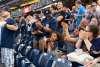 Yankees fans standing to cheer during a game