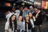 Group of Yankees fans gathered at Yankees stadium posing for a picture