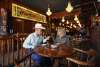 Couple enjoying wine and appetizers at McClintock Saloon & Chop House in OKC's Stockyards City