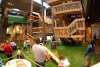 Parents watch the children enjoying the indoor play space at the Science Museum Oklahoma.