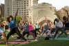 Large group practicing yoga on the Myriad Gardens lawn