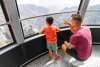 dad and son on tramway car