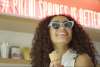 Girl eating ice cream with sunglasses on.