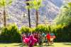 Group of drag queens running on the lawn.
