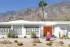 Women in front of midcentury house.